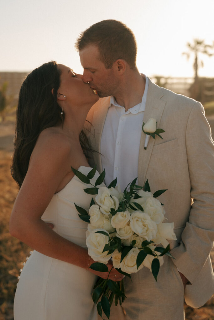 portrait of the bride and groom kissing