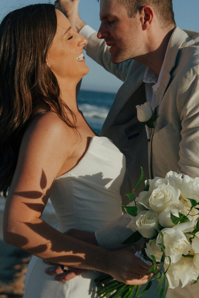 bride and groom laughing with each other