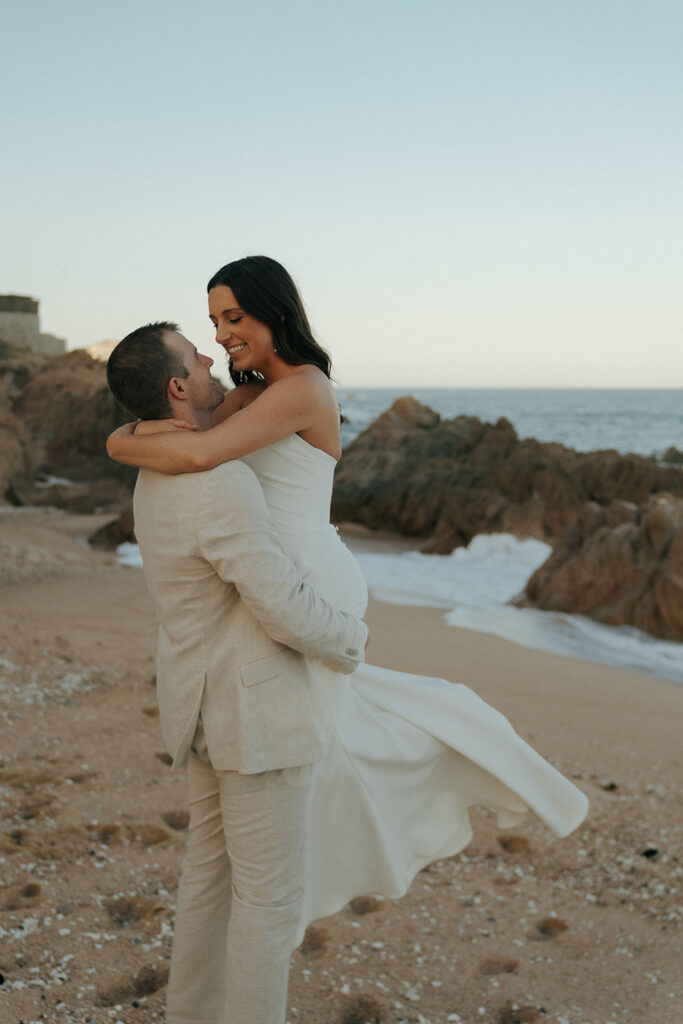 bride and groom dancing at the beach