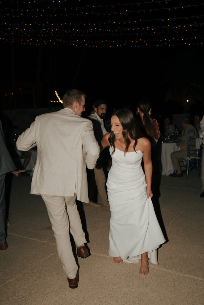 happy newly married couple dancing at their wedding reception