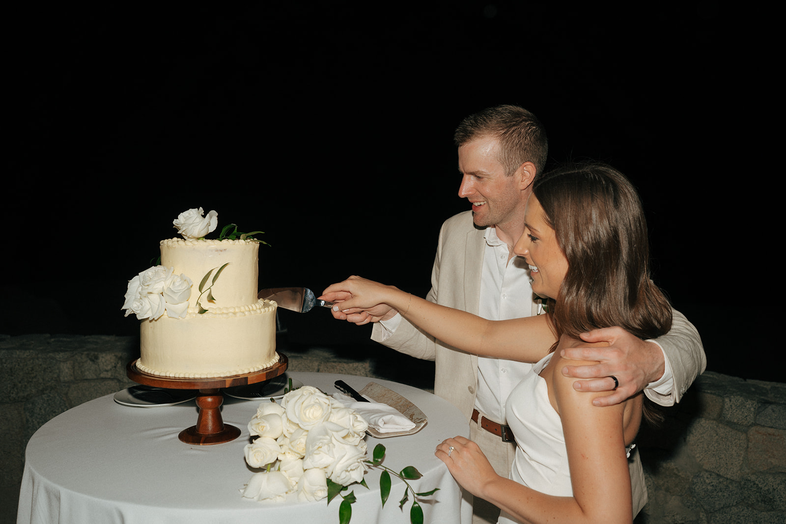 bride and groom cutting their wedding cake