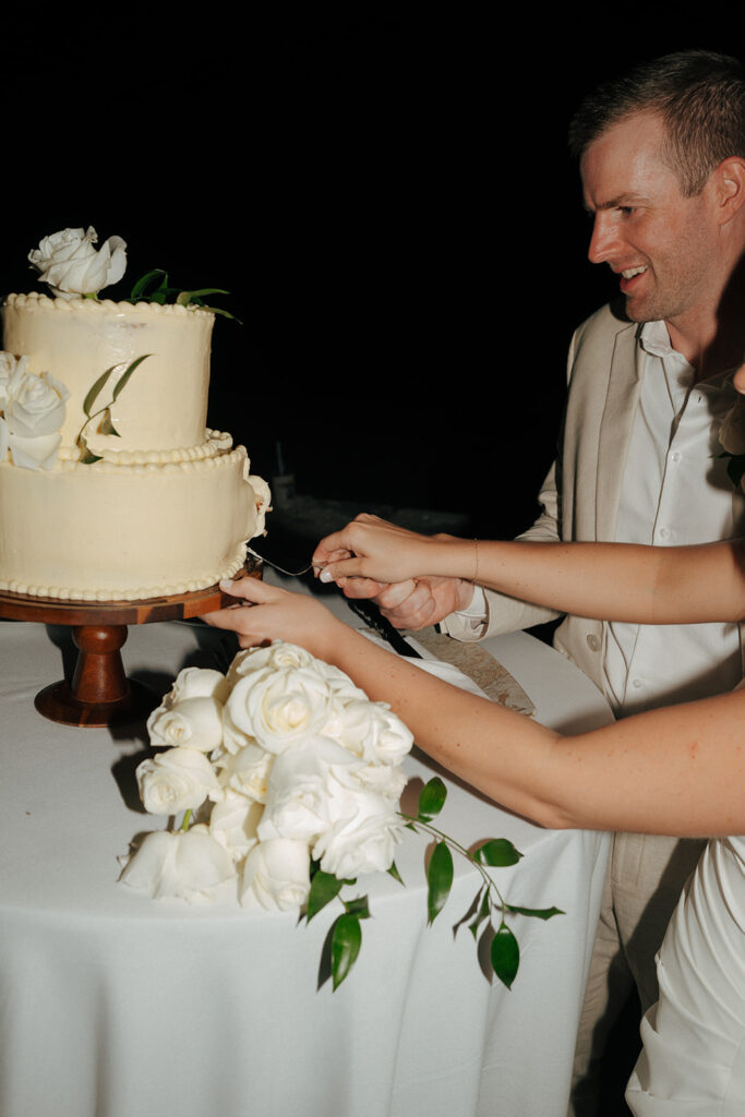 bride and groom cutting their wedding cake