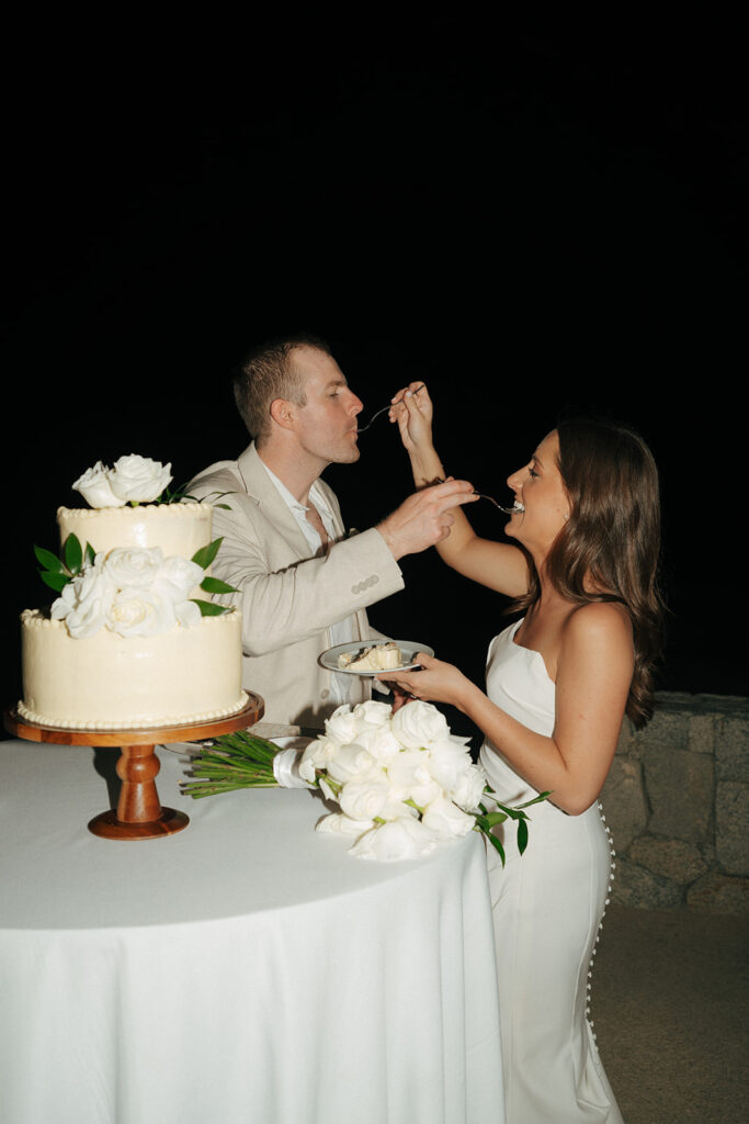 bride and groom trying their wedding cake