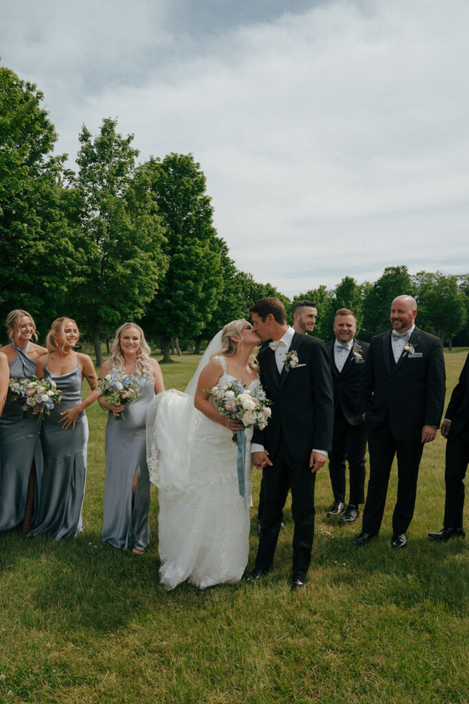 bride and groom holding hands kissing