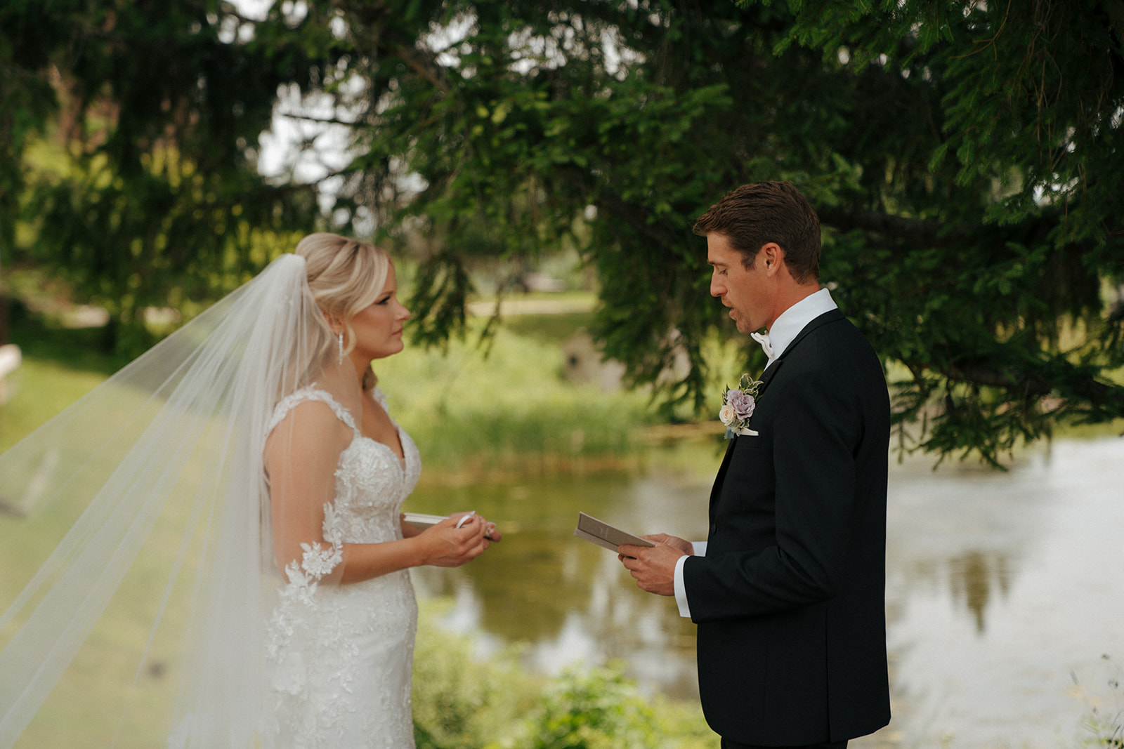 bride and groom reading their wedding vows before their colorful wedding ceremony