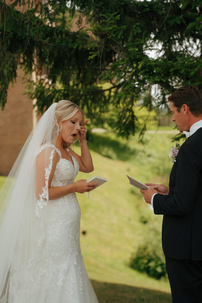 bride emotional while reading her wedding vows