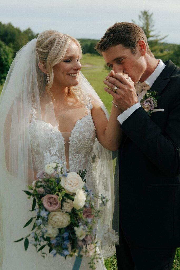 groom kissing the brides hand