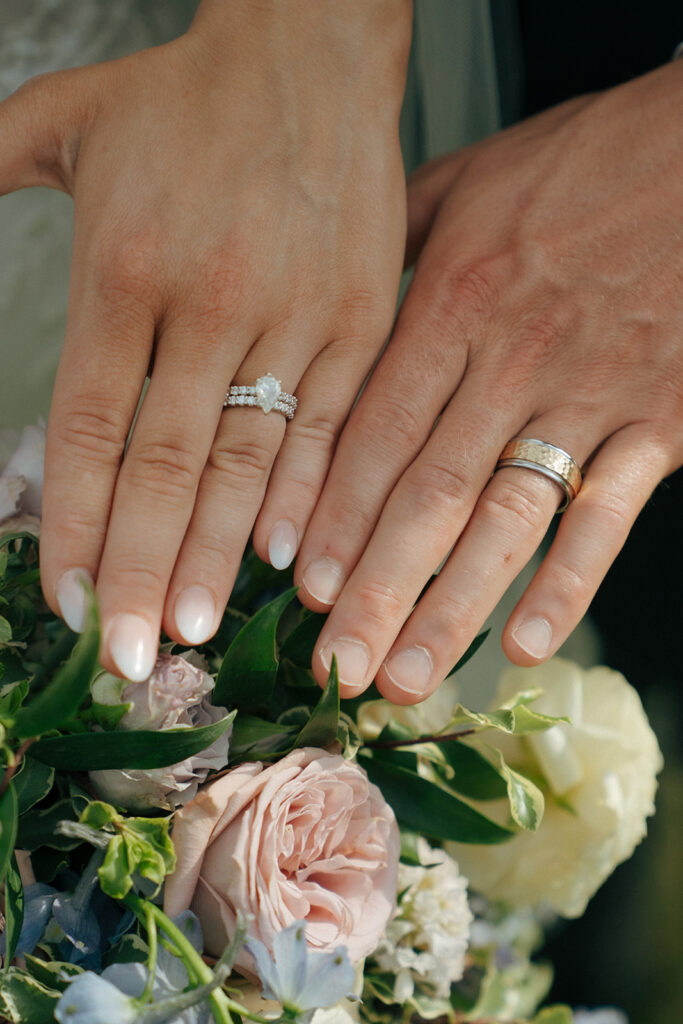 closeup shot of the bride and groom wearing their wedding rings