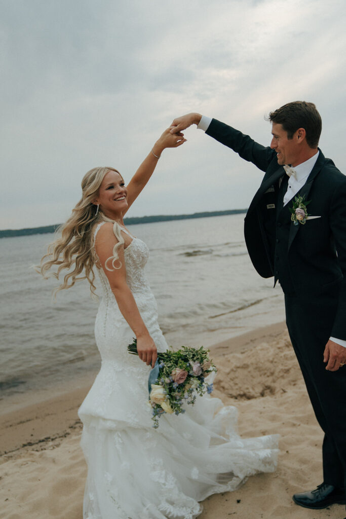 bride and groom dancing at the beach