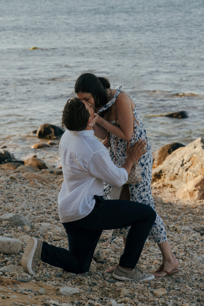 newly engaged couple kissing