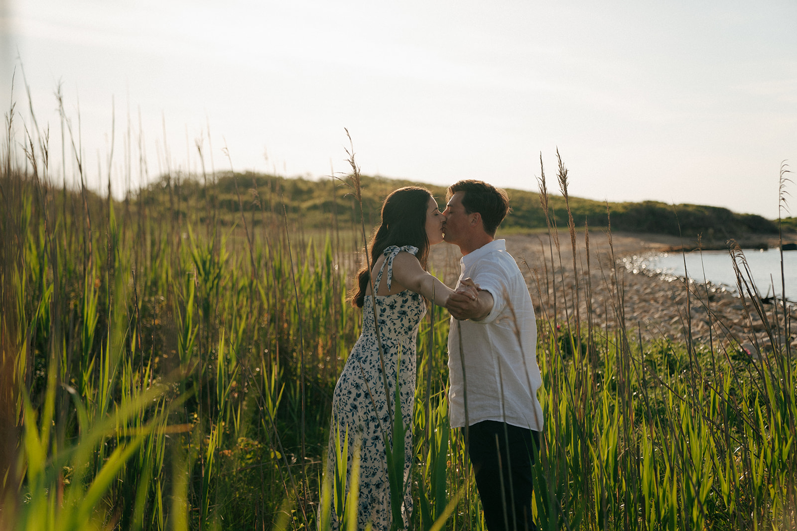 newly engaged couple kissing 