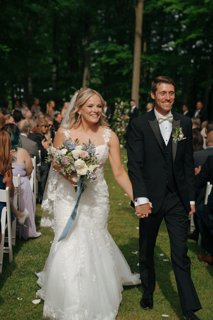 bride and groom heading to their colorful wedding reception