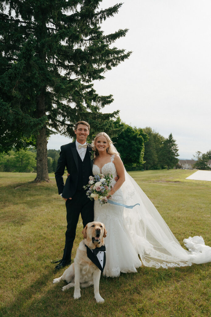 cute portrait of the bride and groom with their cute dog