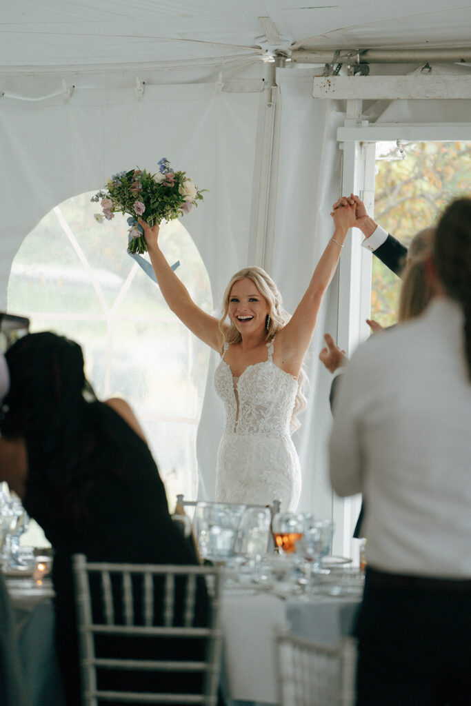 bride and groom entering their colorful wedding reception