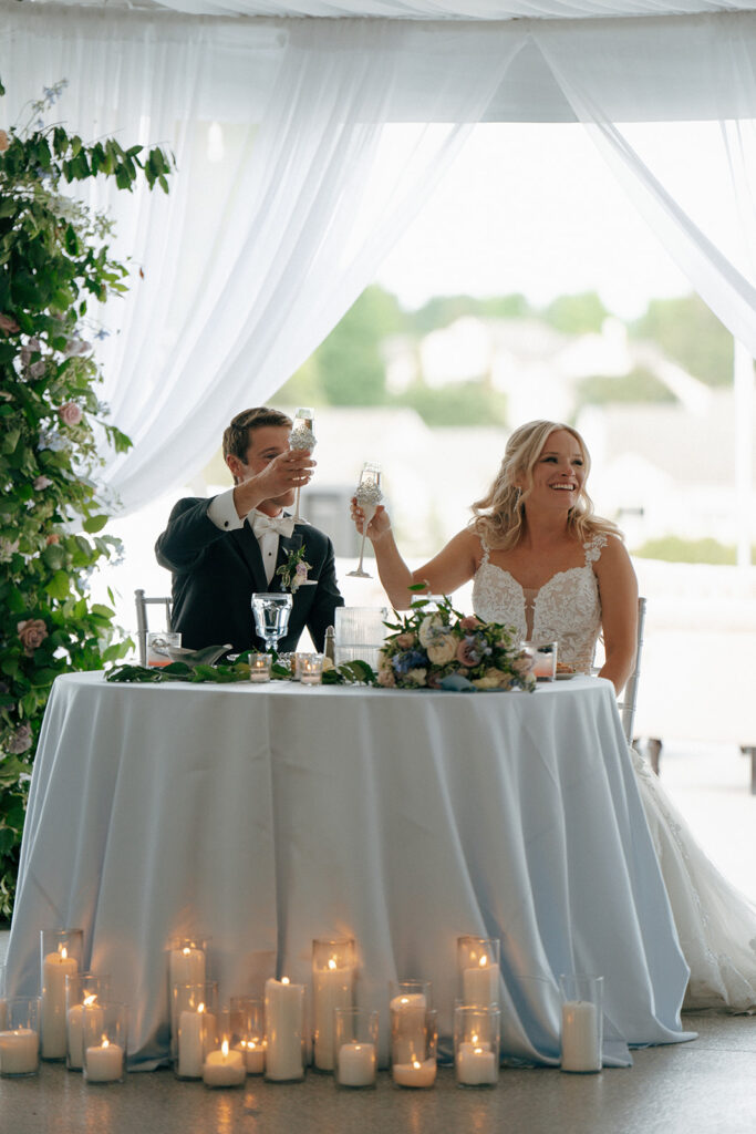 bride and groom drinking champagne