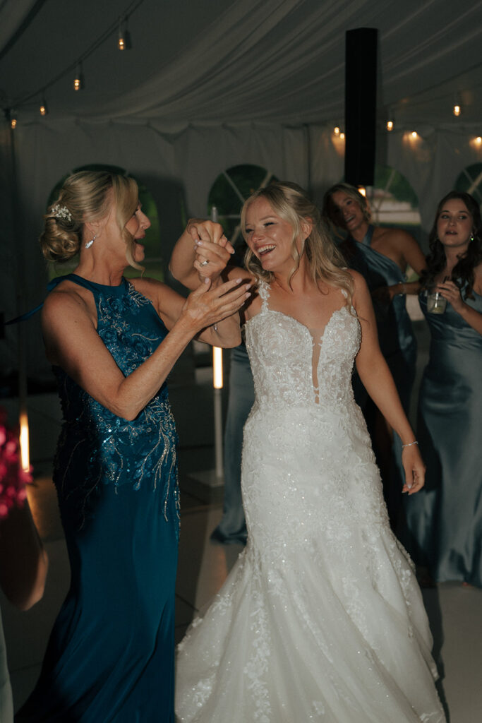 bride dancing with her mom at the colorful wedding reception party