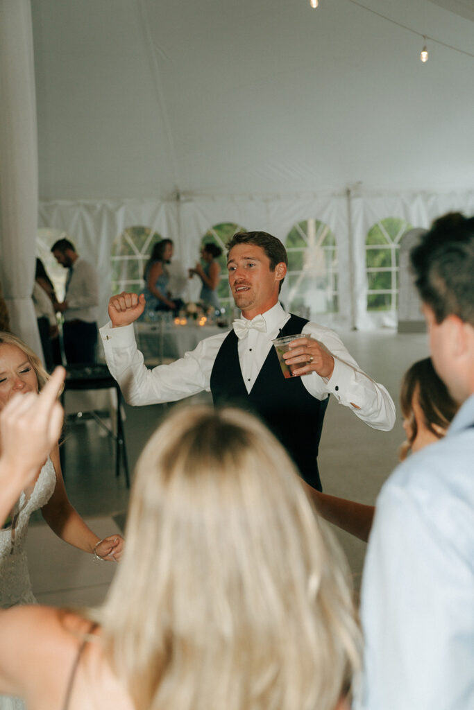 groom dancing at the wedding reception