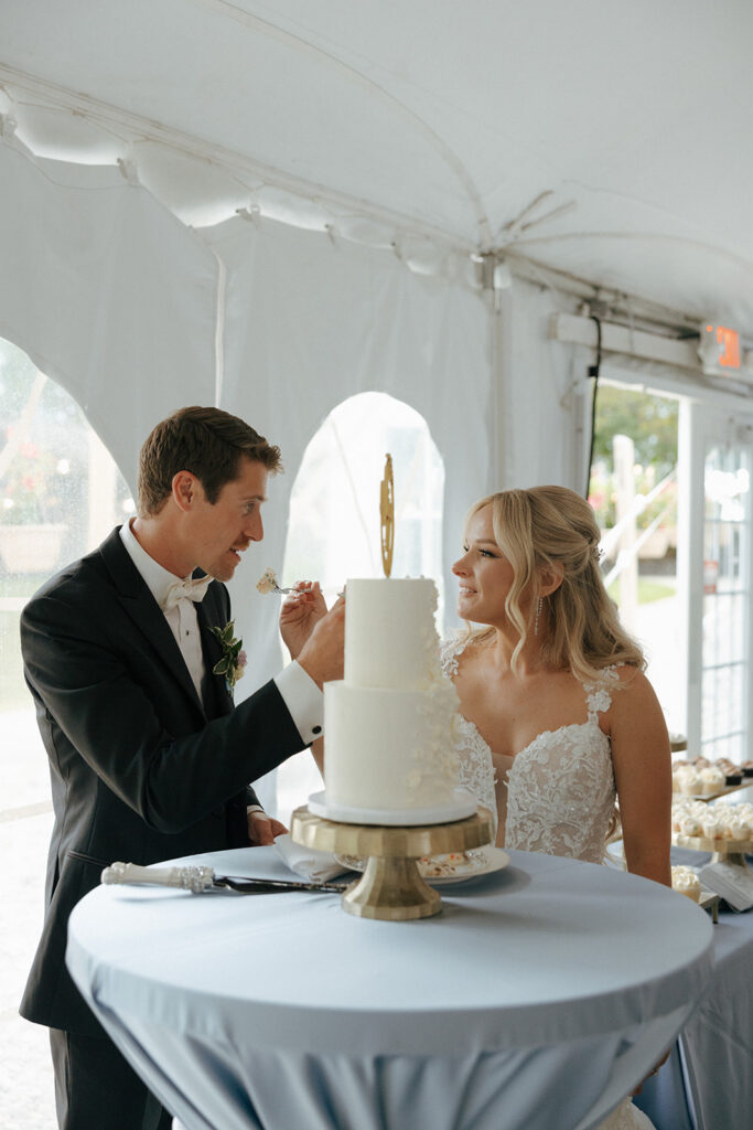 bride and groom trying their wedding cake