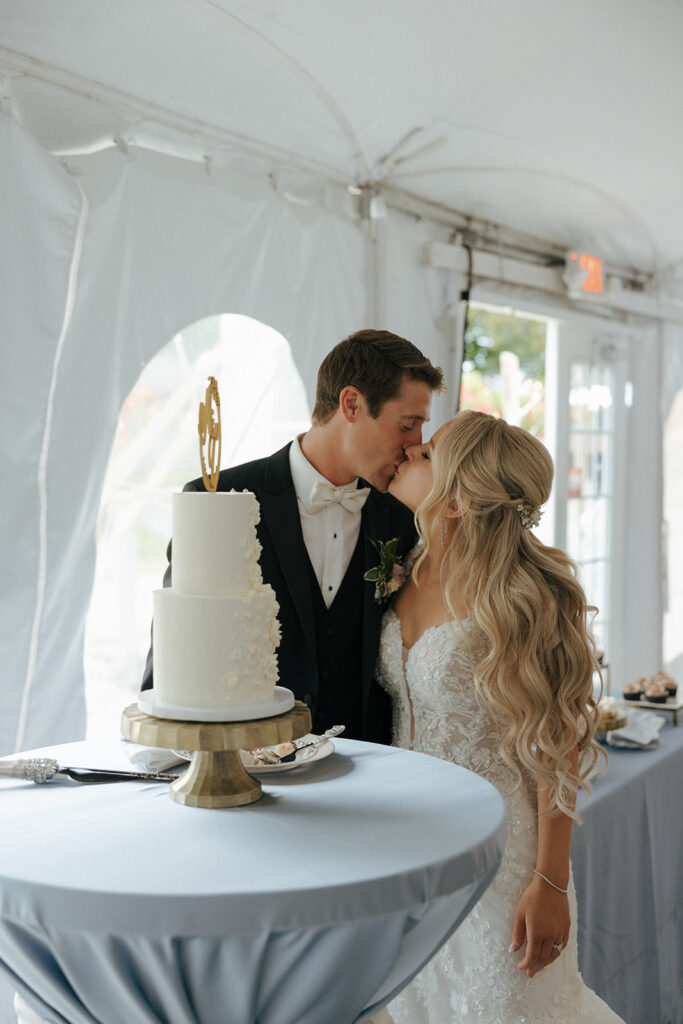 bride and groom kissing at their colorful wedding reception