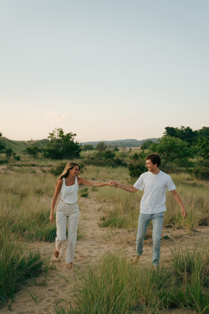 newly engaged couple holding hands