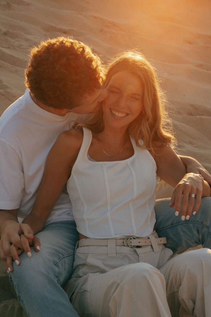 fiance kissing his fiance on the cheek