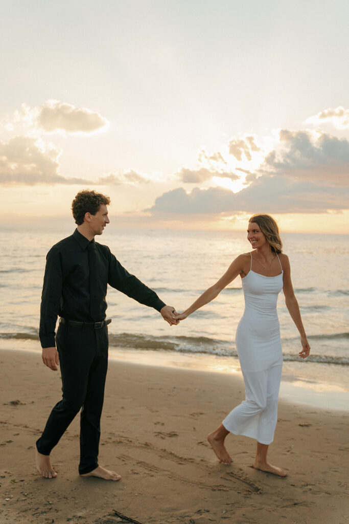 couple walking around oval beach