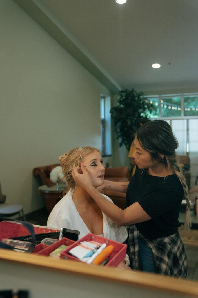 bride getting her makeup done for her summer wedding