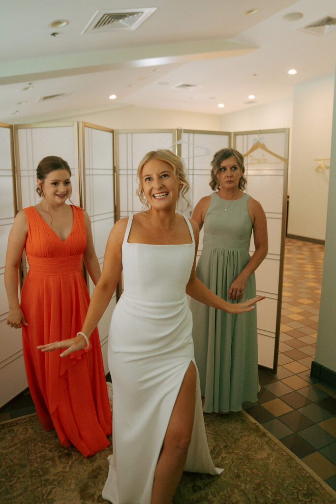 bride putting on her wedding dress for the wedding ceremony