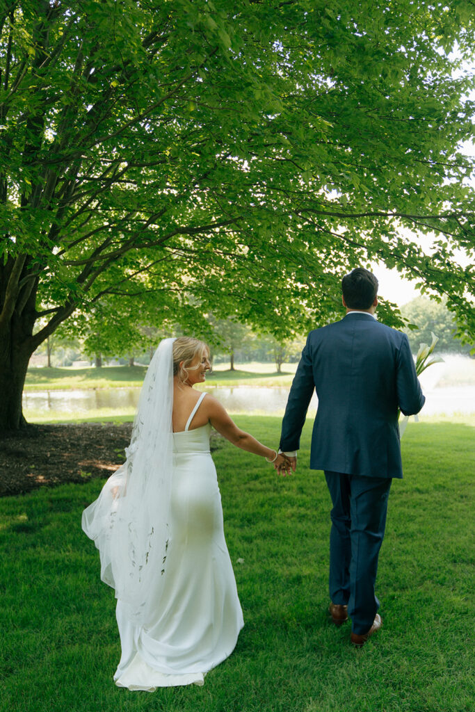 bride and groom walking around their summer wedding ceremony