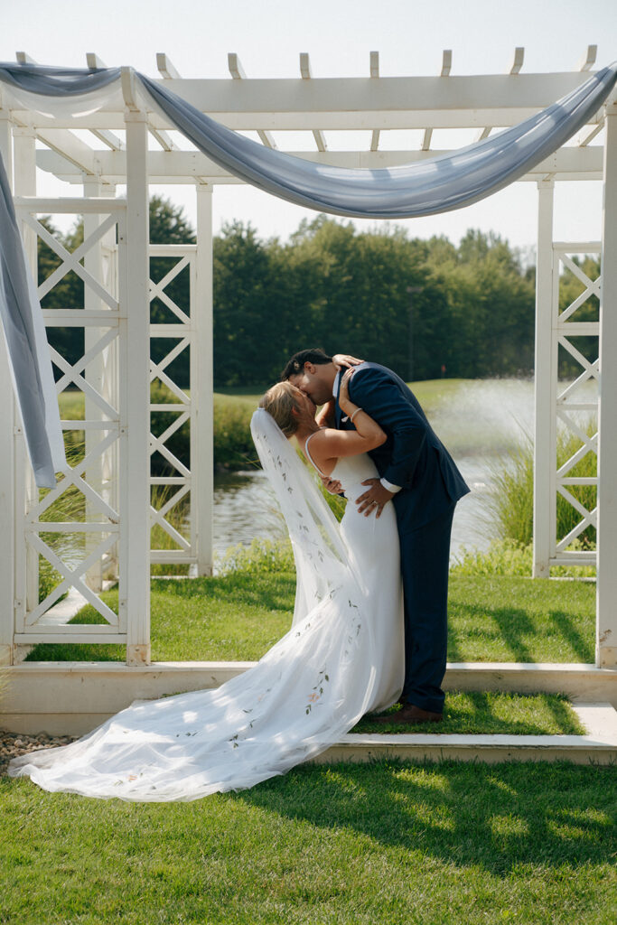 bride and groom kissing after their wedding ceremony