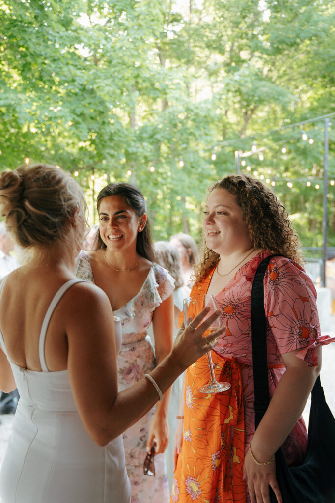 bride talking with her guests at the cocktail hour