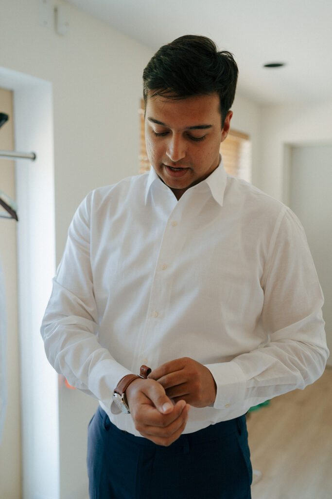 groom getting ready for his summer wedding