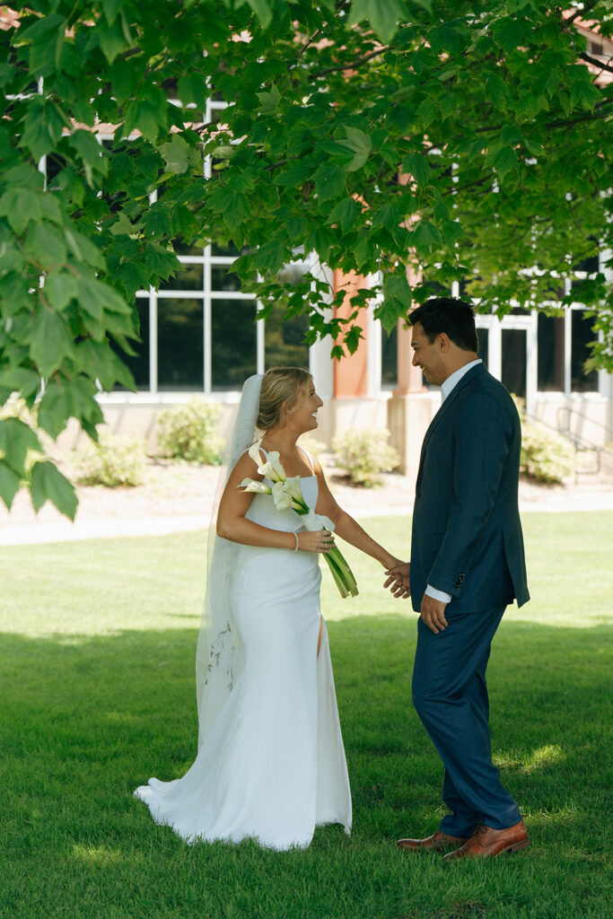 bride and groom holding hands during their first look