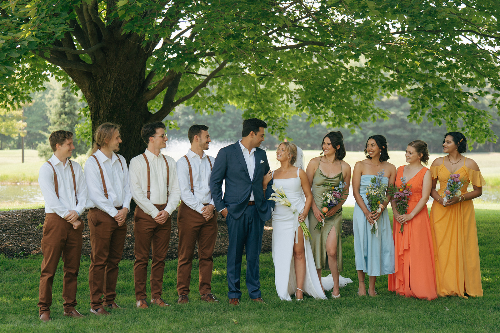 bride and groom with their friends at the summer wedding