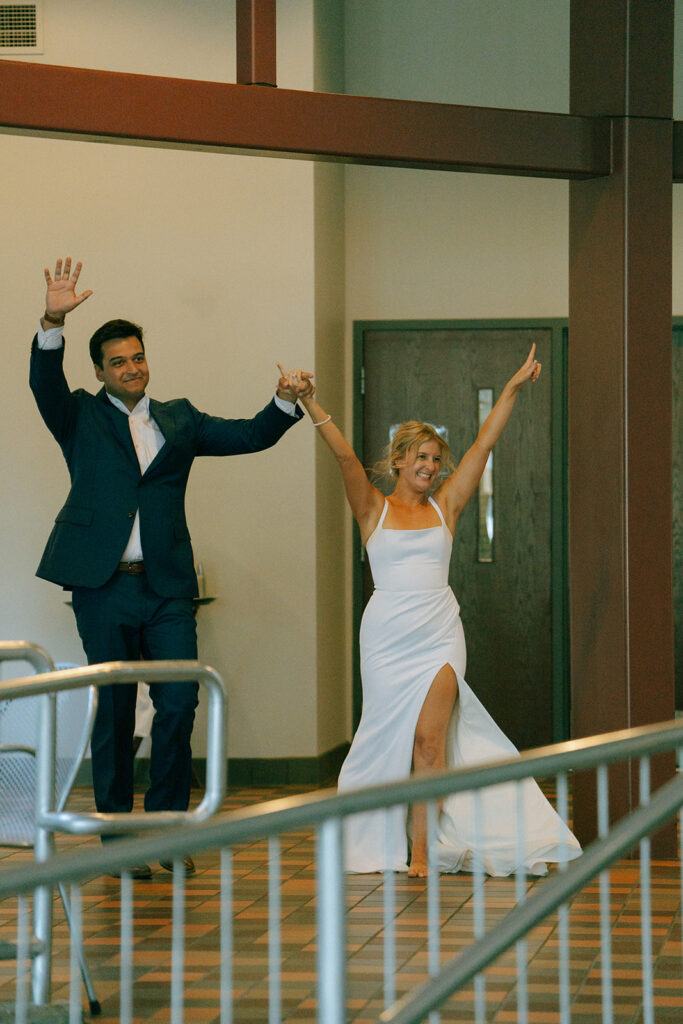 bride and groom entering their wedding reception