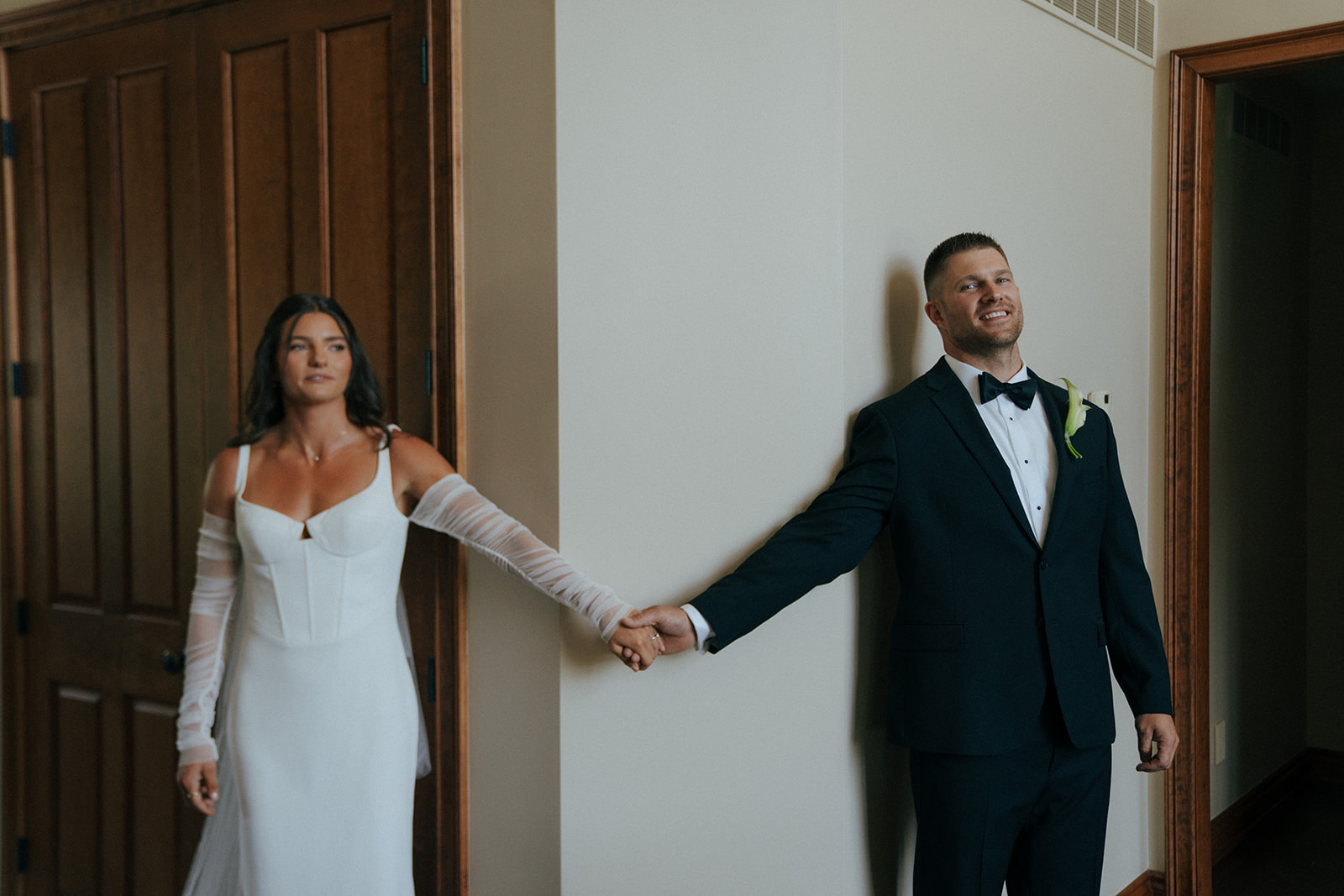 bride and groom first touch before their backyard wedding