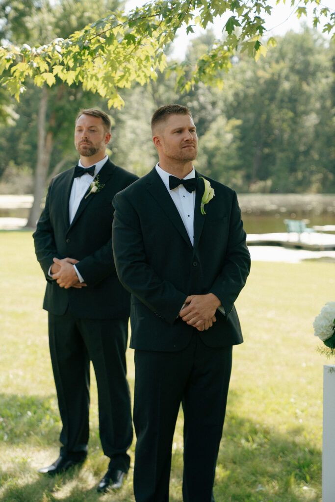 groom watching the bride walk down the aisle