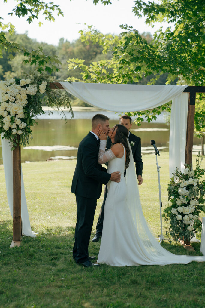 bride and groom kissing after their wedding ceremony