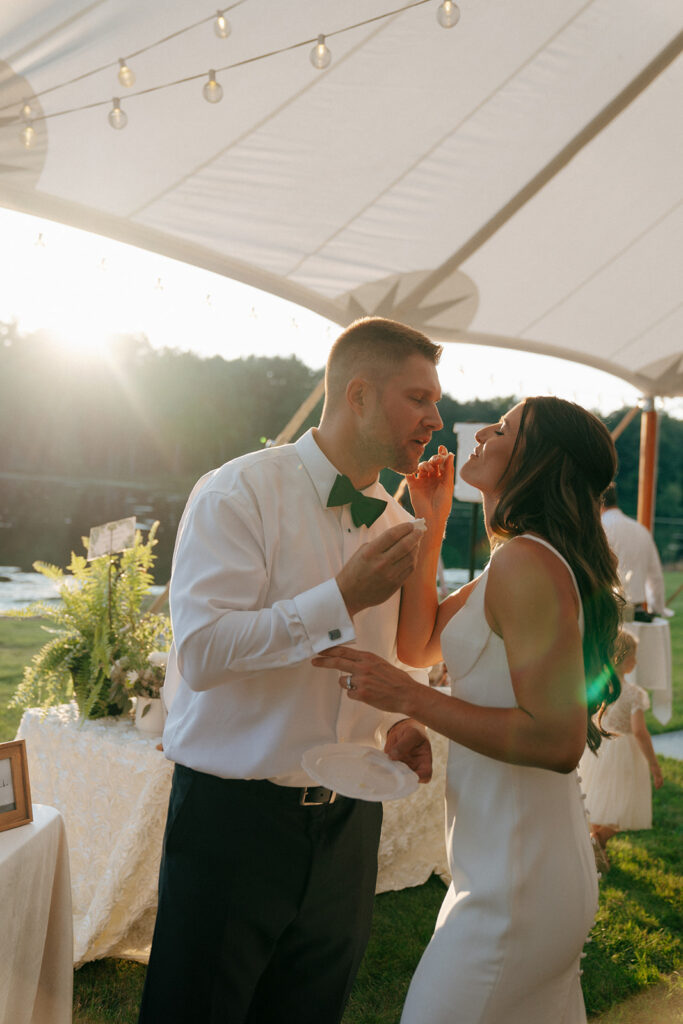 couple trying their wedding cake