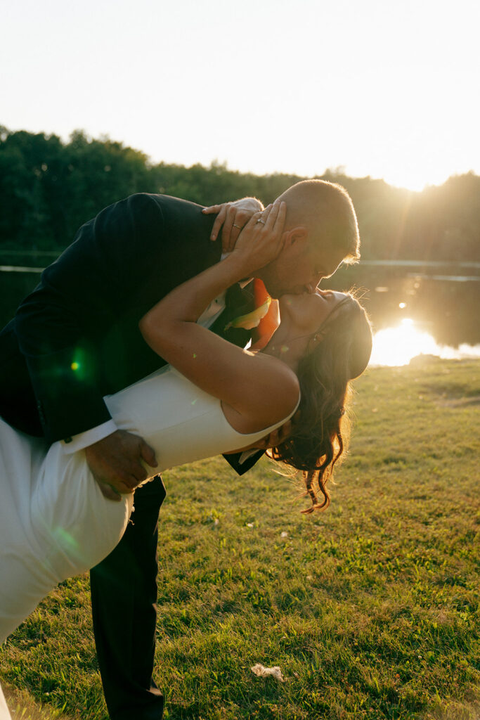 golden hour picture of the newlyweds kissing