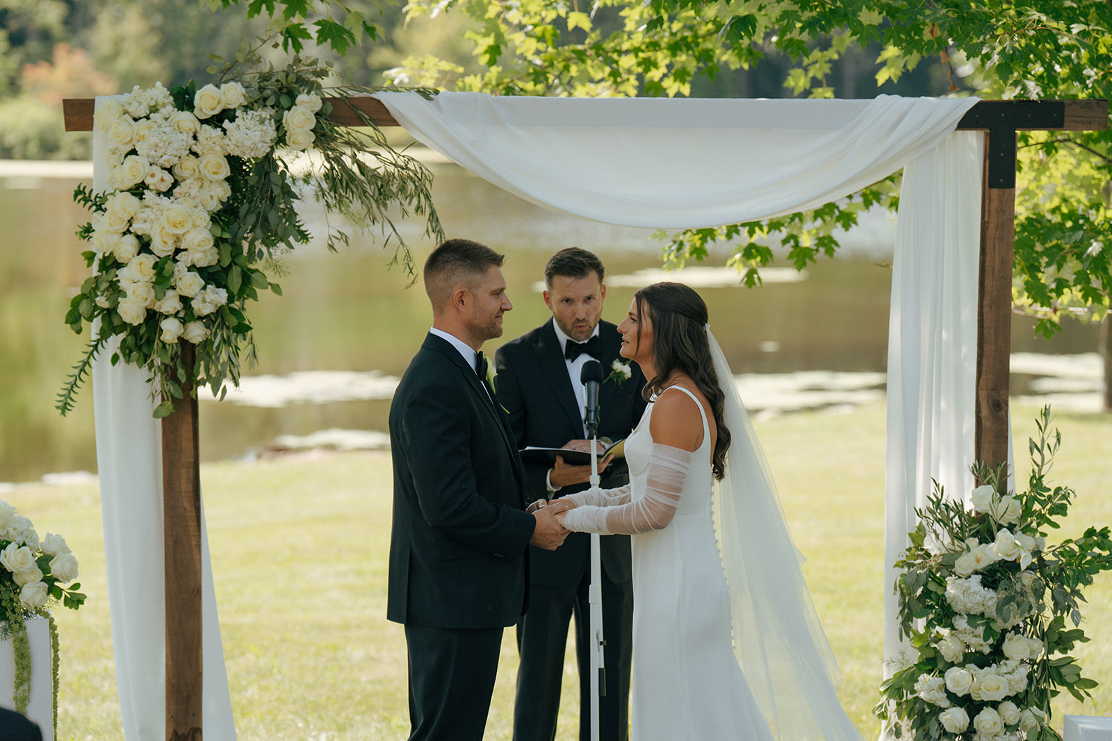 bride and groom holding hands during their wedding ceremony