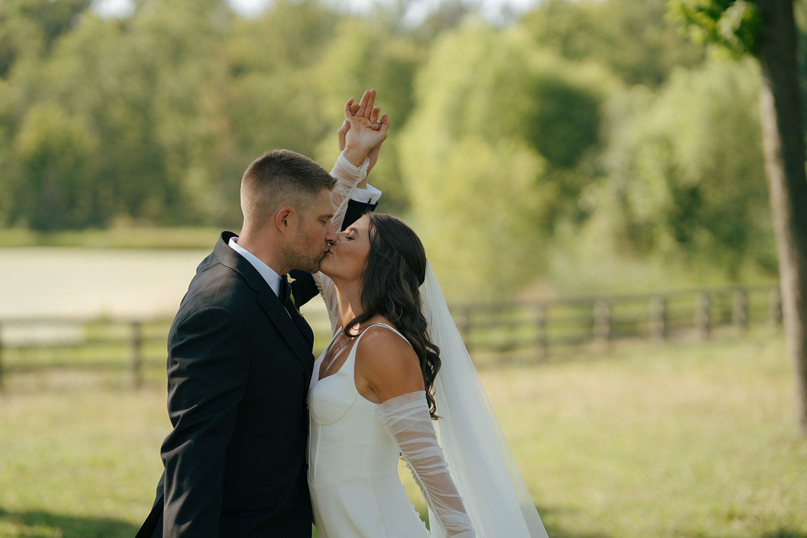 bride and groom kissing at their candid backyard wedding