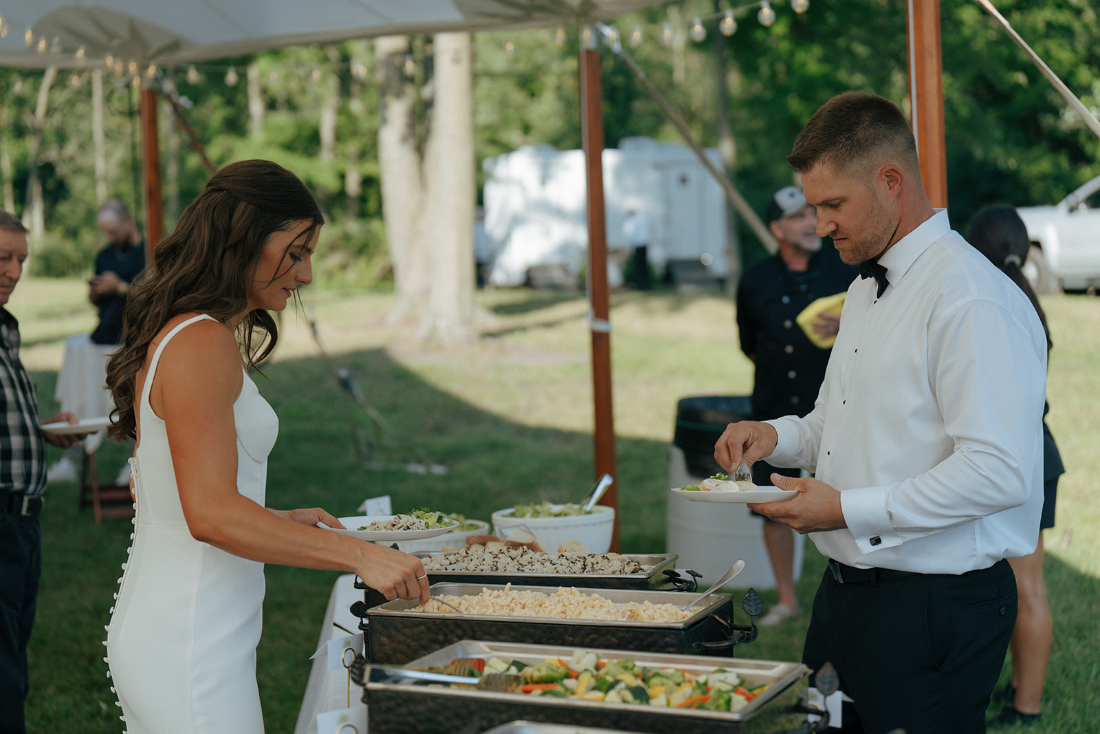 bride and groom eating at their wedding reception