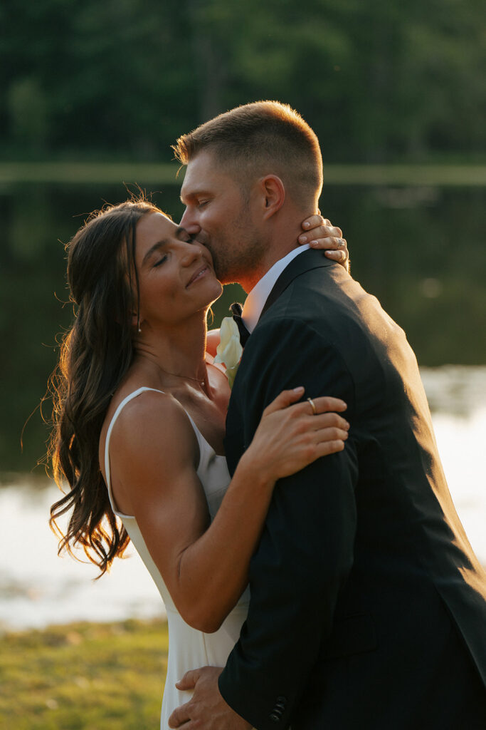 groom kissing the bride on the cheek