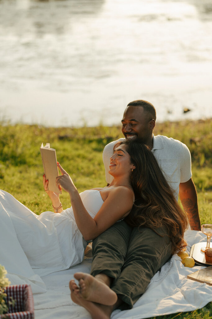 couple reading a book during their picnic