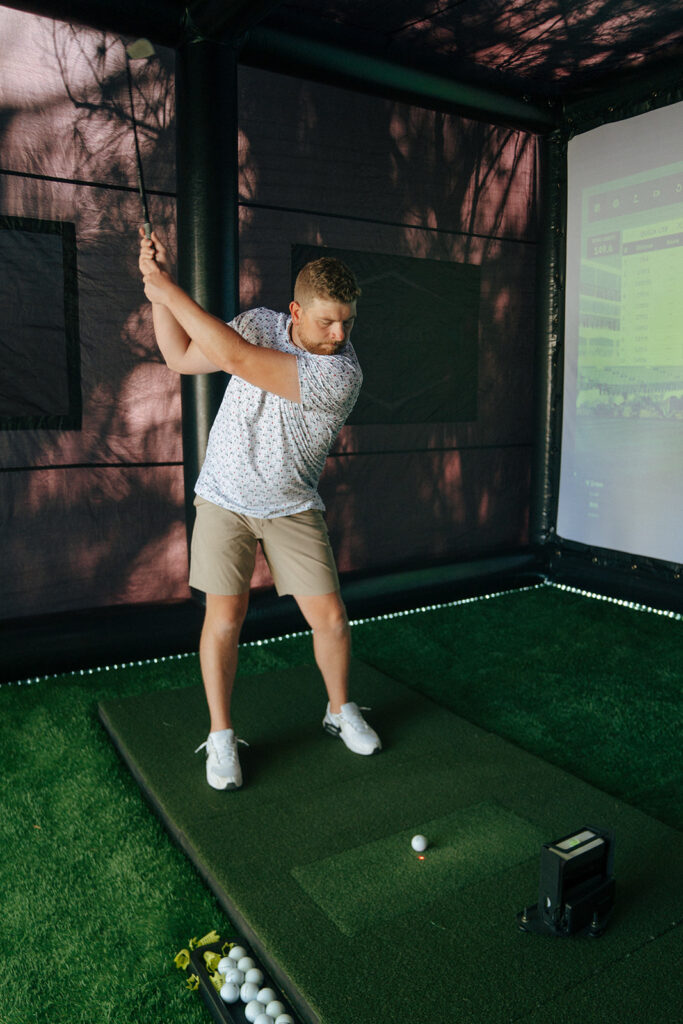 groom playing a golf simulator before getting ready