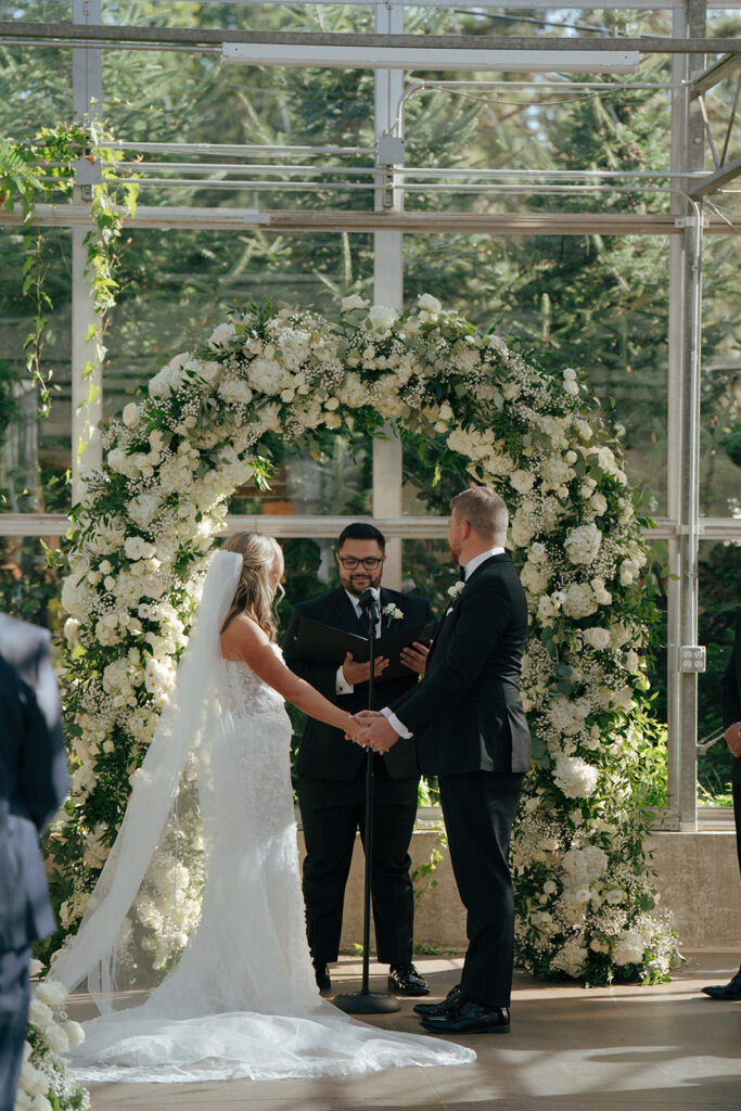 bride and groom holding hands at their timeless wedding ceremony