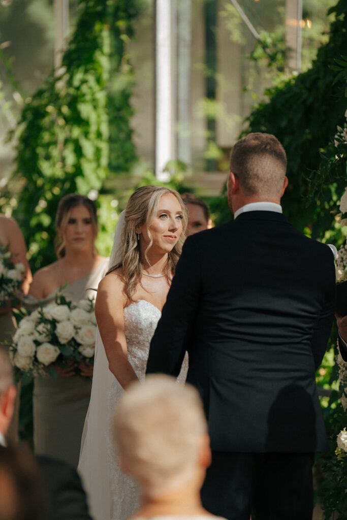 bride and groom looking at each other during their wedding ceremony