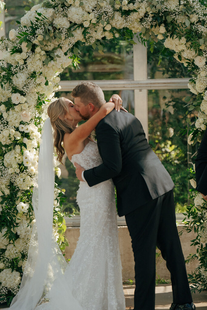 bride and groom kissing after their wedding ceremony