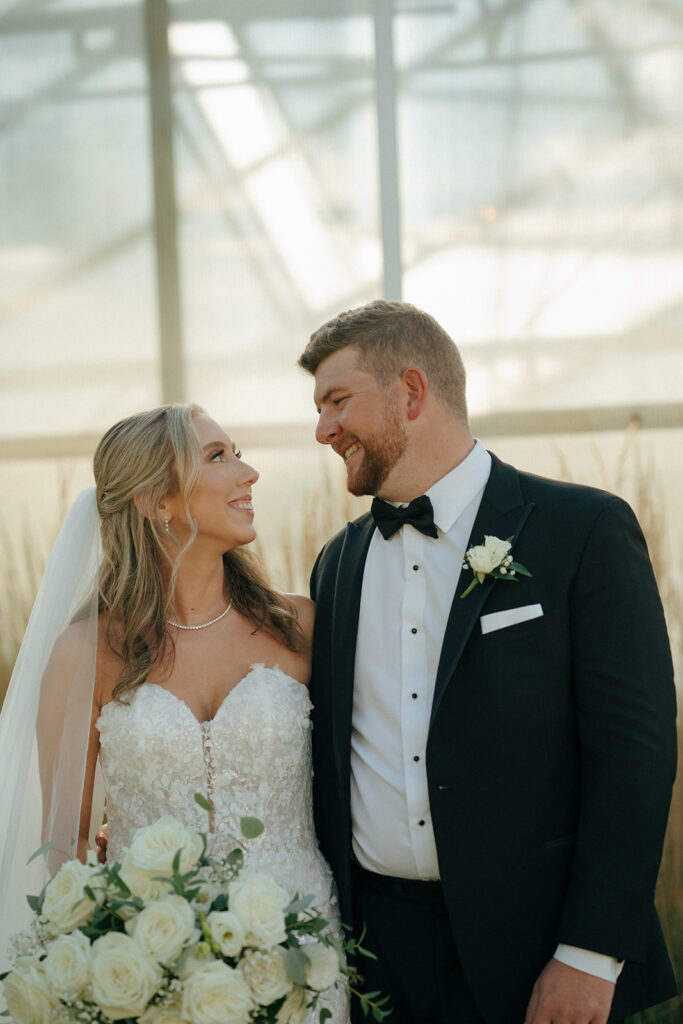 cute bride and groom smiling at each other